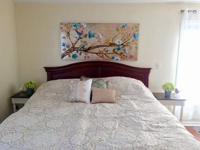 Cozy bedroom with decorative artwork on the wall