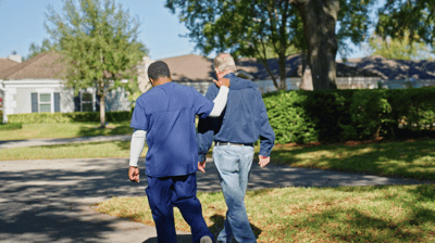 Staff member assisting a resident outdoors