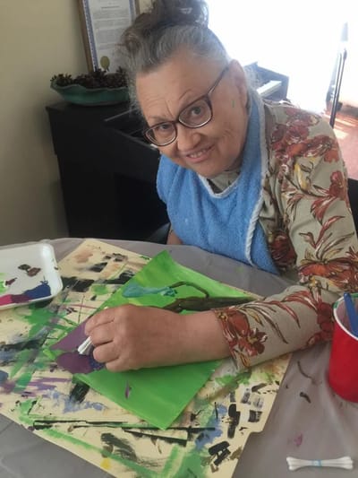 Resident painting in a colorful art activity