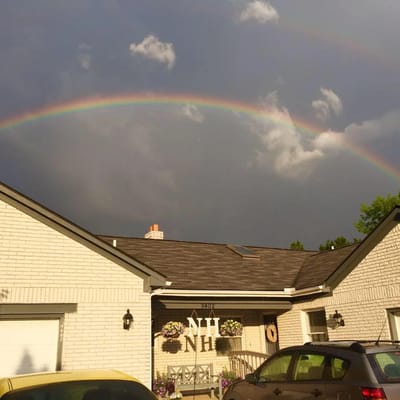 Exterior view of the building with a rainbow