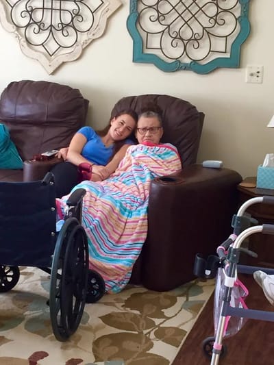 Two residents seated together in a cozy lounge area