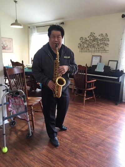 A resident playing saxophone in a common area