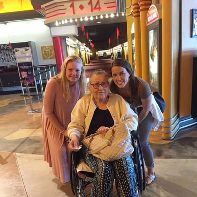 Residents and staff members smiling together in a hallway