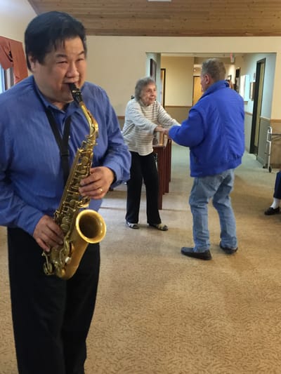Residents enjoying a music event in a common area