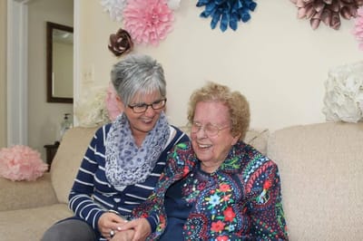 A staff member and resident sharing a joyful moment