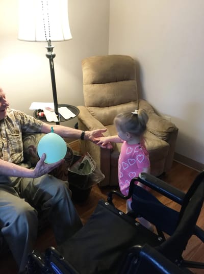 Resident interacting with a child in a cozy room