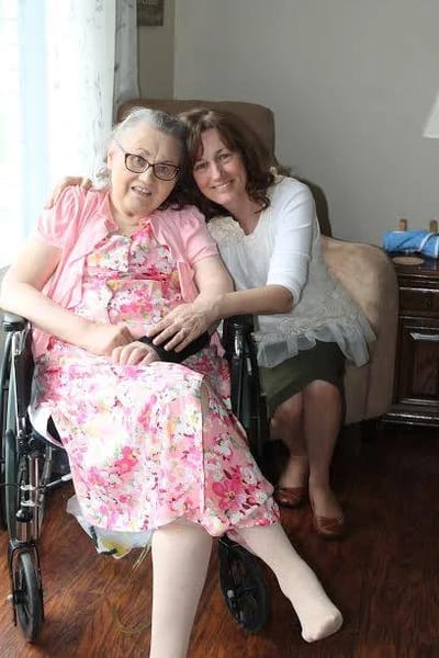 Two women smiling in a cozy living room