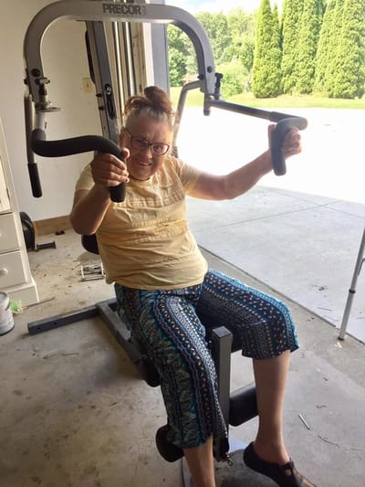 Resident exercising on a fitness machine in an indoor space