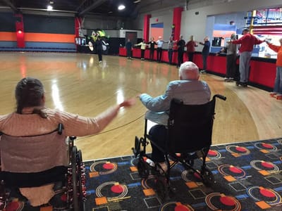 Residents participating in a fun skating activity indoors