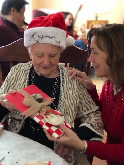 Resident receiving a gift during a holiday celebration