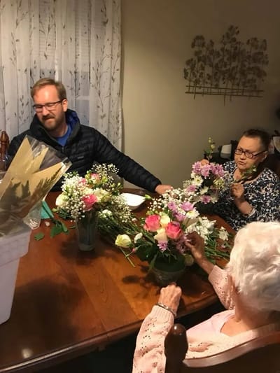 Residents participating in a flower arranging activity