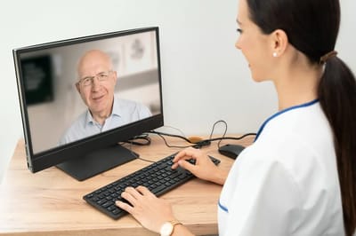 Nurse interacting with a senior via video call.