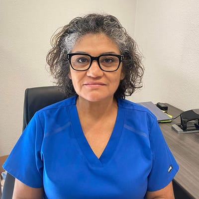 Female staff member in blue scrubs