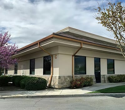 Exterior view of the facility building with landscaping.