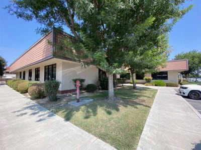 Exterior view of a single-story facility with landscaping.