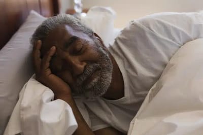 Senior man peacefully sleeping in bed
