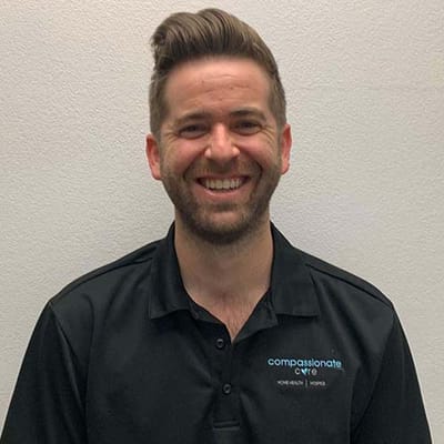 Smiling staff member in a branded shirt