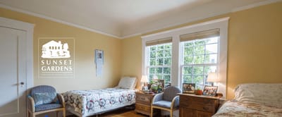 Interior view of a resident room with Sunset Gardens logo