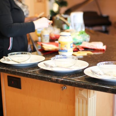 Preparing a meal in the kitchen with set plates