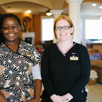Staff members smiling in a cozy facility environment
