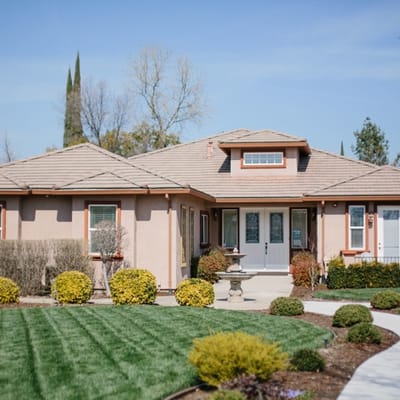 Exterior view of an assisted living facility with landscaped garden