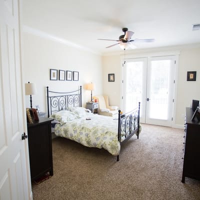 Brightly lit resident room with a comfortable bed