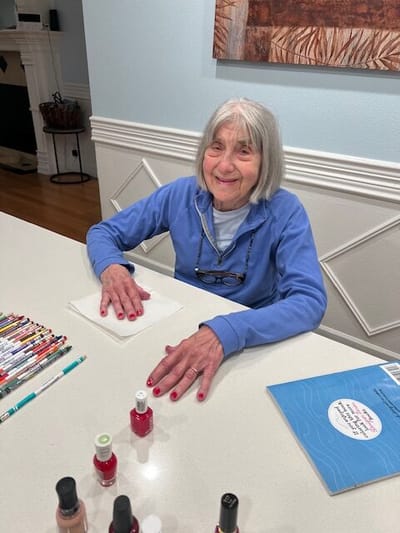 Resident enjoying a nail painting activity