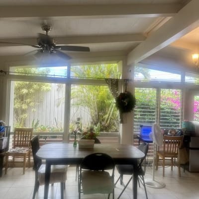 Bright common area with dining table and plants