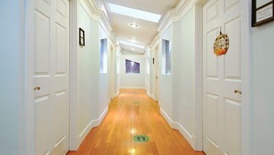 Bright hallway with wooden floors and doors