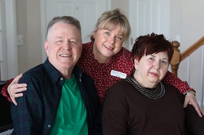 Residents and staff posing together in a common area