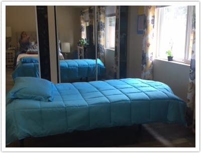 Interior view of a resident's room with a bed and window