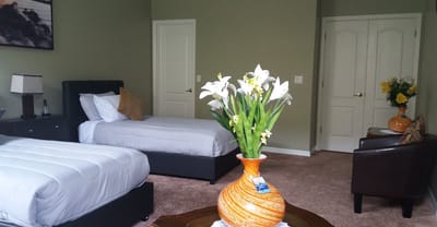 Shared resident room with two beds and flowers