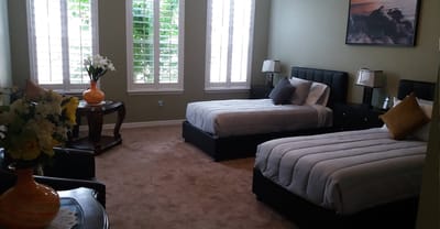 A neatly arranged resident bedroom with two beds