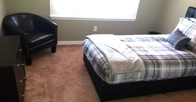 Cozy bedroom with a bed and armchair