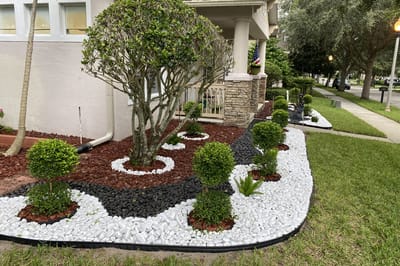 Well-maintained outdoor landscaping with decorative rocks and plants