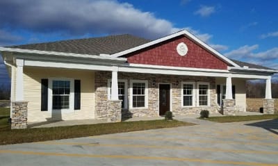 Exterior view of a senior living facility with a porch