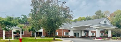Front view of Woodhaven Retirement Community's exterior with garden