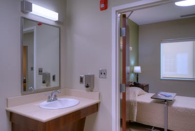 Interior view of a resident room with bed and amenities