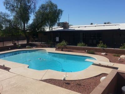 Pool area with a landscaped yard at the facility