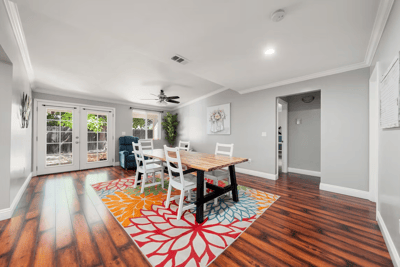 Bright common area with dining table and chairs