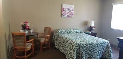 Cozy resident room with a bed and seating area.