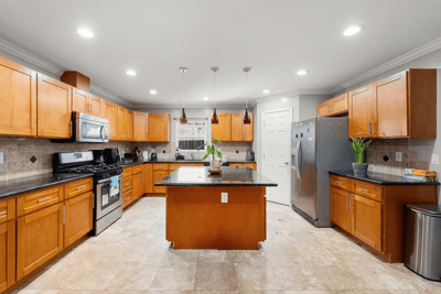 Spacious kitchen with wooden cabinets and modern appliances.
