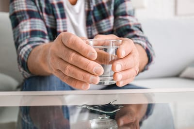 Person holding a glass of water