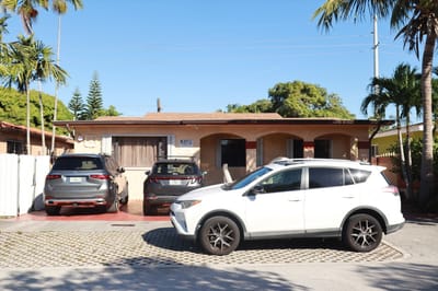 Exterior view of Maylu Retirement Home with vehicles