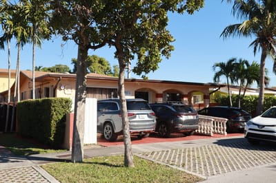 Exterior view of Maylu Retirement Home with parked vehicles