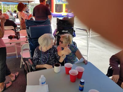 Residents enjoying a social moment at an outdoor event