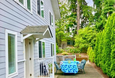 Outdoor patio area with tables and greenery