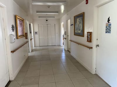 A clean hallway with wall art and handrails