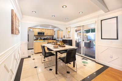 Bright dining area with a table and kitchen view