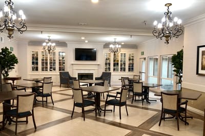 Bright common area with dining tables and seating